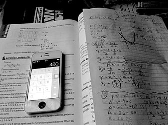 Open math textbook with handwritten notes and iPhone calculator