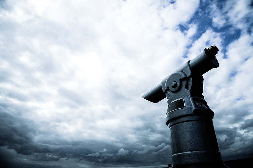 Low angle view of a cannon against dramatic cloudy sky
