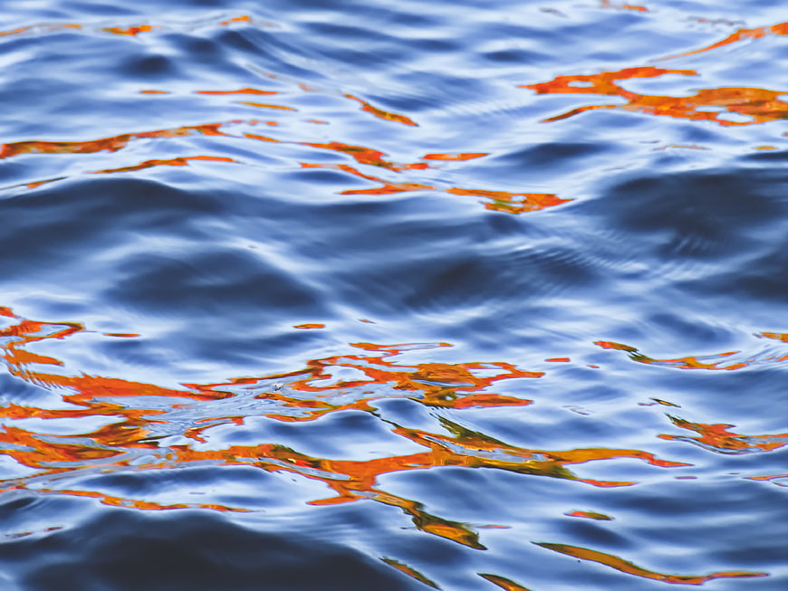 Abstract Blue Water Ripples with Orange Reflections