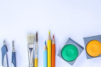 Flat lay of colorful art supplies and drawing tools on white background