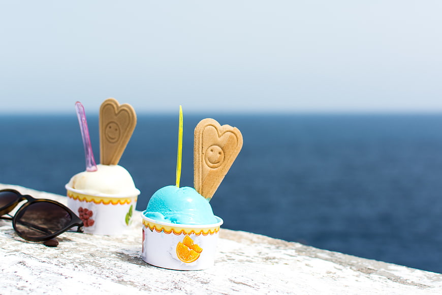 Blue and white ice cream cups with wafers by the sea