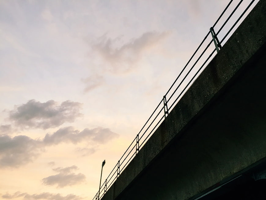 Concrete Bridge Silhouette Against Soft Sunset Sky