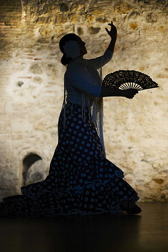 Flamenco dancer silhouette with fan in traditional dress