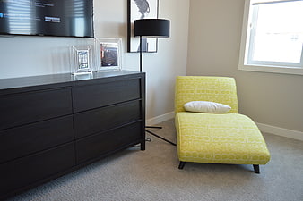 Modern Bedroom Interior With Yellow Chaise Lounge And Dark Dresser