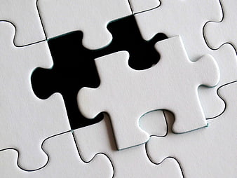White jigsaw puzzle with missing piece and black background