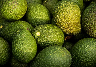 Close-up of fresh green Hass avocados with textured skin