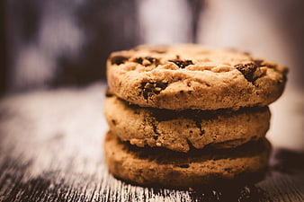 Stack of chocolate chip cookies on rustic wooden table