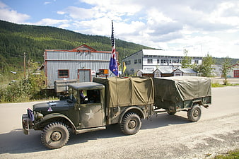 Vintage military truck with trailer on gravel road