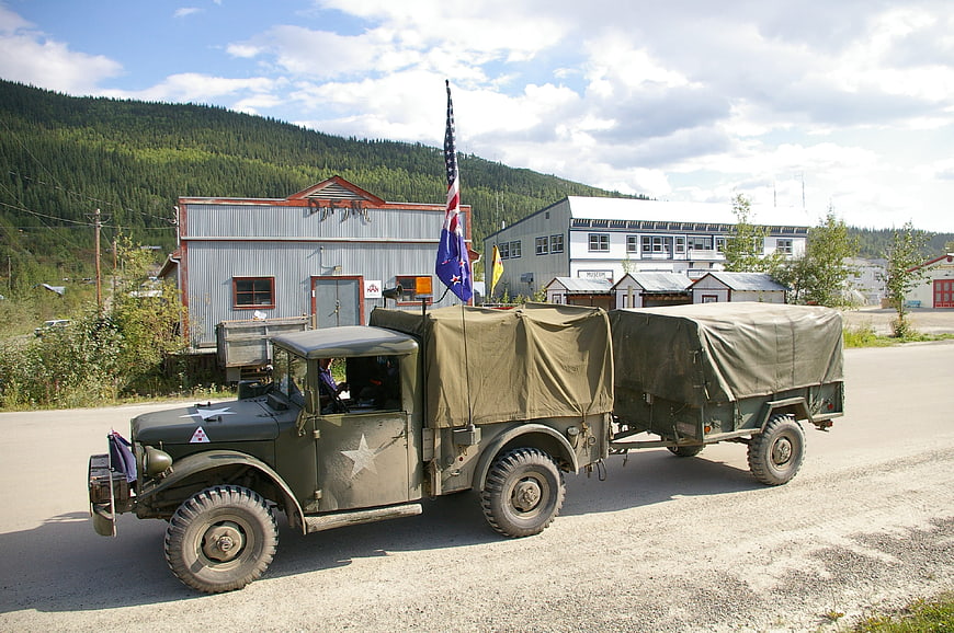 Vintage military truck with trailer on gravel road