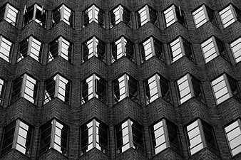 Black and white architectural facade with repeating window pattern