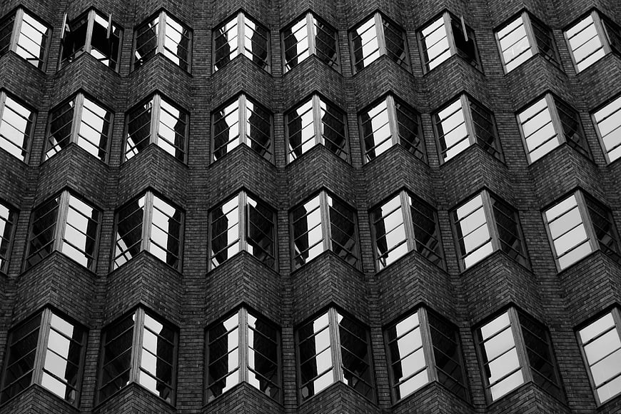 Black and white architectural facade with repeating window pattern