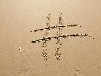 Hashtag Symbol Drawn in Sand on Beach