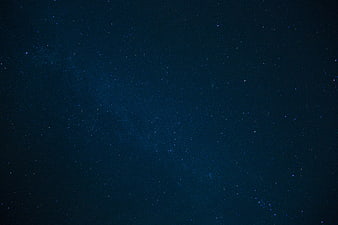 Deep blue night sky filled with stars and faint Milky Way