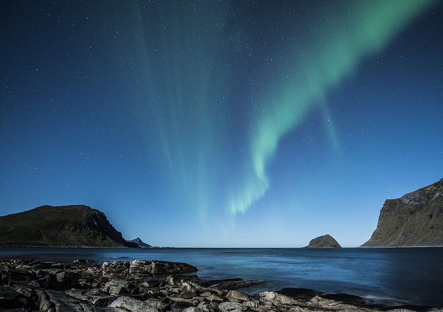 Aurora Borealis over Rocky Coastline in Lofoten Islands