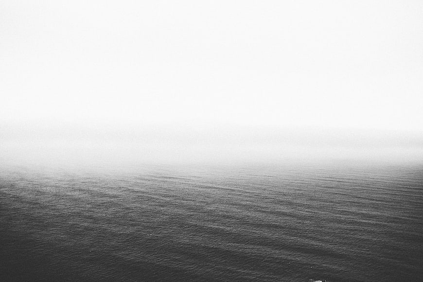 Minimalist Black and White Ocean Horizon in Fog