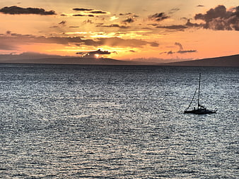 Silhouette of Sailboat on Ocean at Sunset