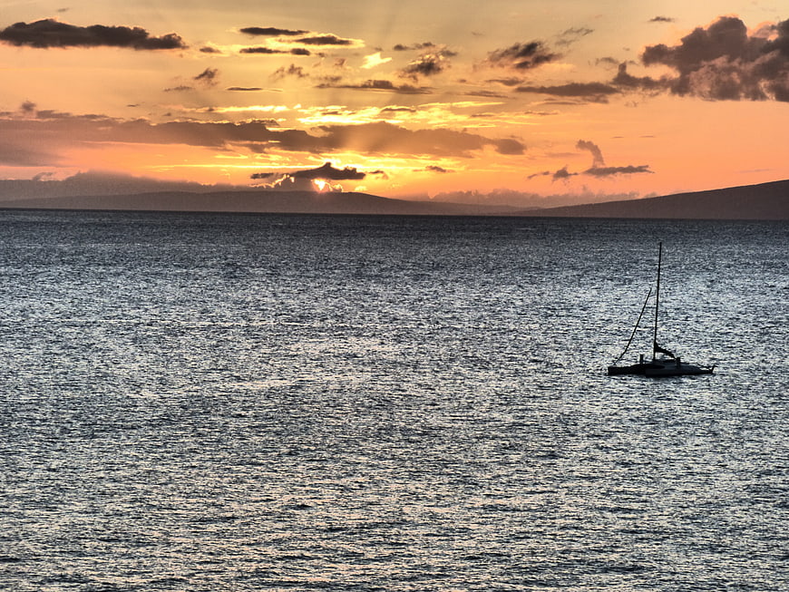 Silhouette of Sailboat on Ocean at Sunset