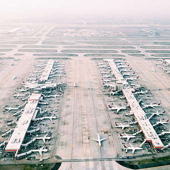 Aerial View of Busy Airport Terminal with Parked Airplanes