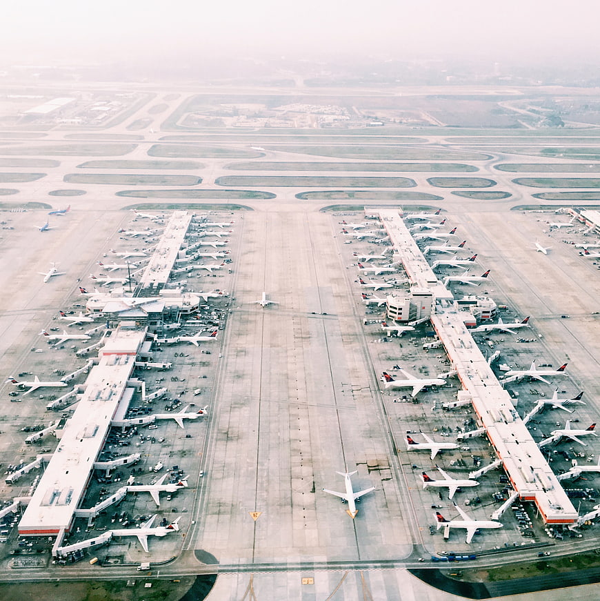 Aerial View of Busy Airport Terminal with Parked Airplanes