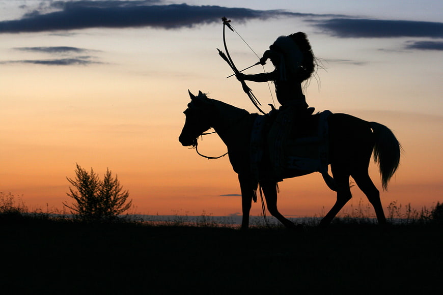 Silhouette of Native American Archer on Horse at Sunset