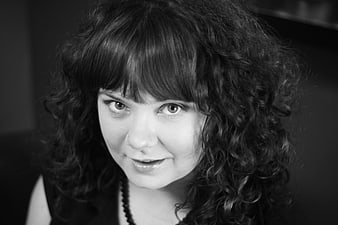 Black and white portrait of smiling woman with curly hair