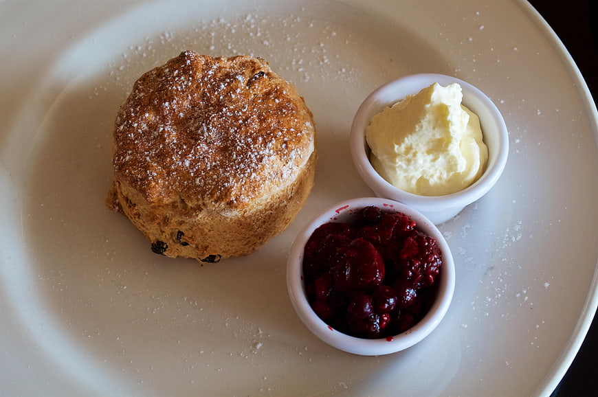 Scone with Clotted Cream and Jam on White Plate