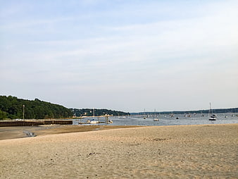 Sandy Beach with Sailboats and Wooden Pier
