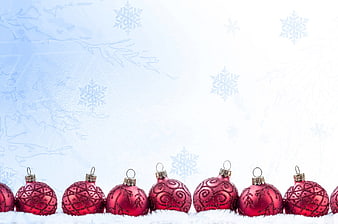 Red Christmas Ornaments on Snow with Blue Background