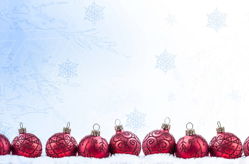 Red Christmas Ornaments on Snow with Blue Background