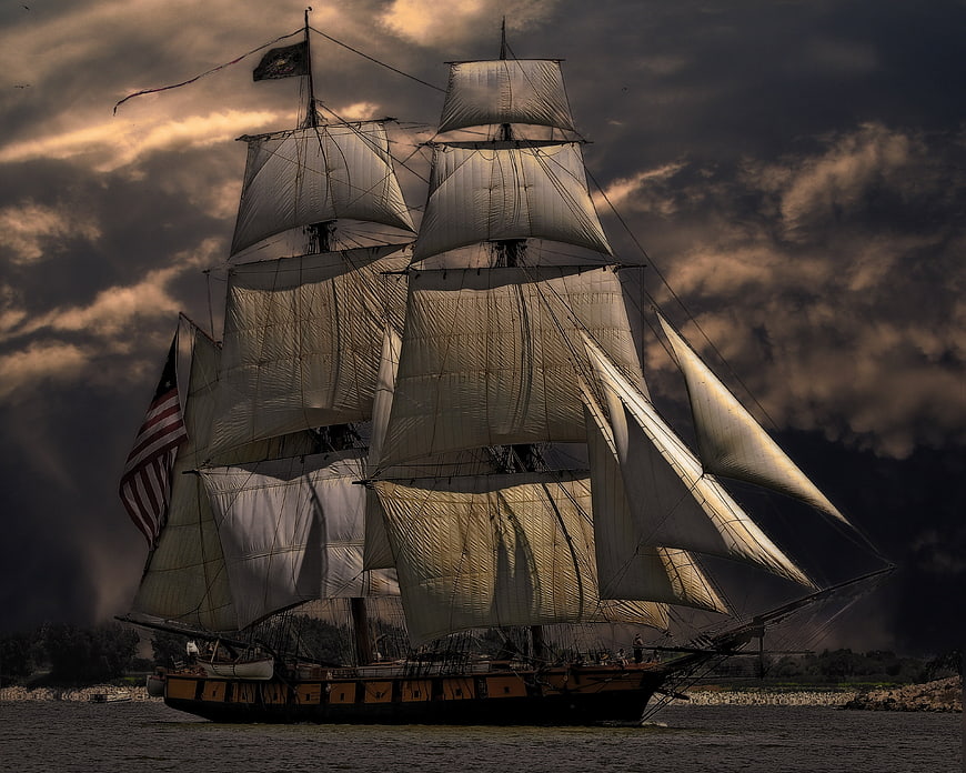 Dramatic Tall Ship Sailing Under Stormy Clouds