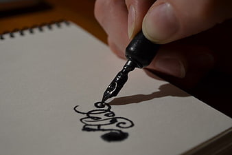 Close-up of hand writing calligraphy with fountain pen