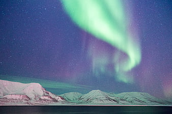 Aurora Borealis Over Snowy Mountains at Night