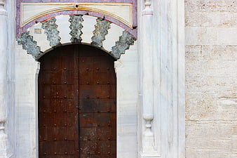 Ancient wooden door with ornate archway in Istanbul