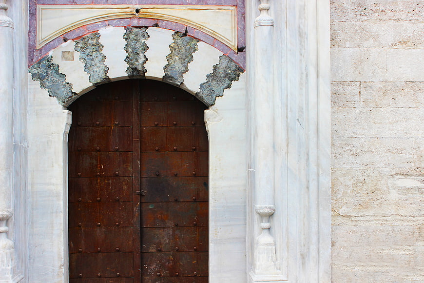 Ancient wooden door with ornate archway in Istanbul