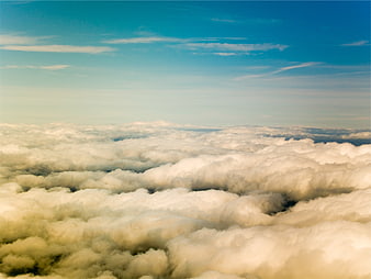 Aerial view of fluffy white clouds under a clear blue sky