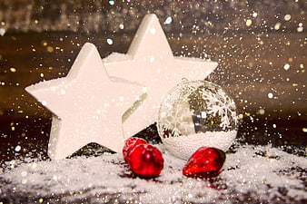 White Christmas Stars and Red Baubles on Snowy Surface
