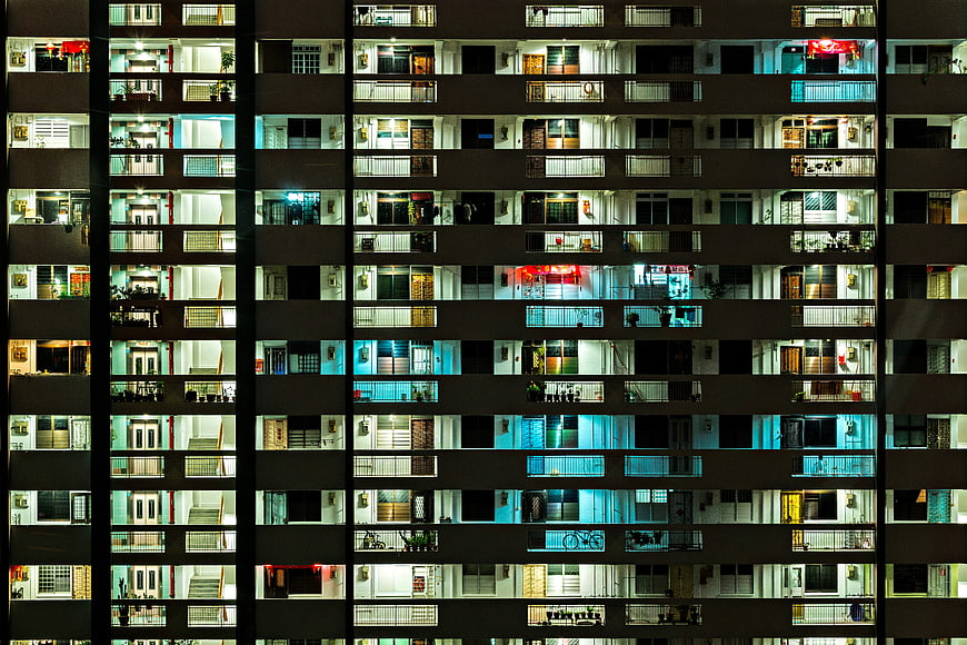 Night view of illuminated Singapore apartment building facade