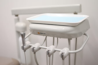 Close-up of modern dental chair unit with instruments