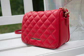 Red Quilted Crossbody Bag on White Bench