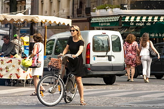 Woman with Bicycle on Busy European City Street