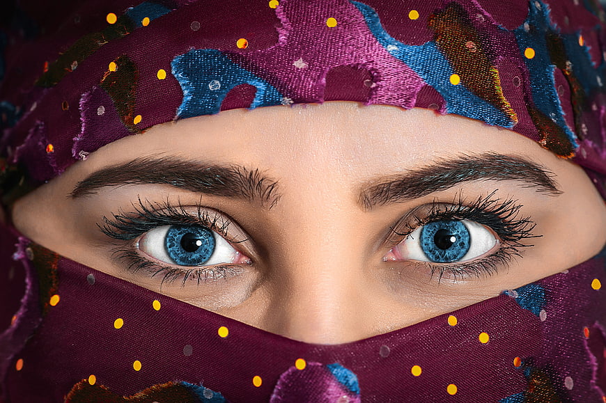 Close-up portrait of a woman wearing a colorful patterned headscarf