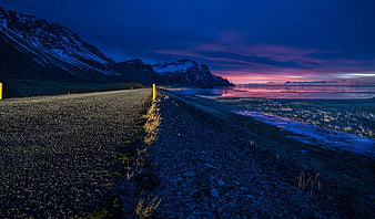 Gravel Road Leading to Snowy Mountains at Twilight