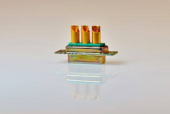 Gold-plated electrical connector with three terminals on white background