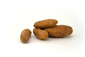 Fresh raw sweet potatoes isolated on white background