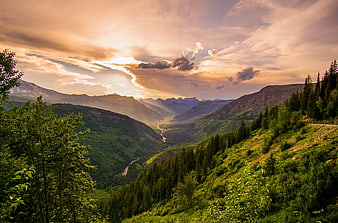 Scenic Mountain Valley Landscape with Golden Hour Sunlight