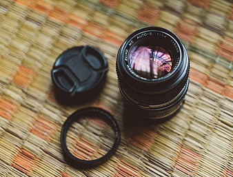 Vintage Zuiko Camera Lens on Woven Mat