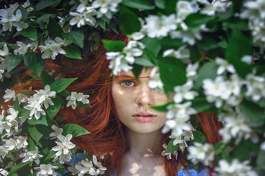 Redhead Woman Surrounded by White Jasmine Flowers
