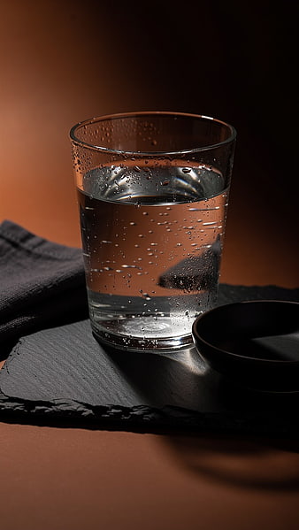 Glass of Sparkling Water on Slate with Bubbles