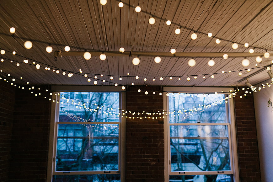 Cozy Interior with String Lights and Brick Walls