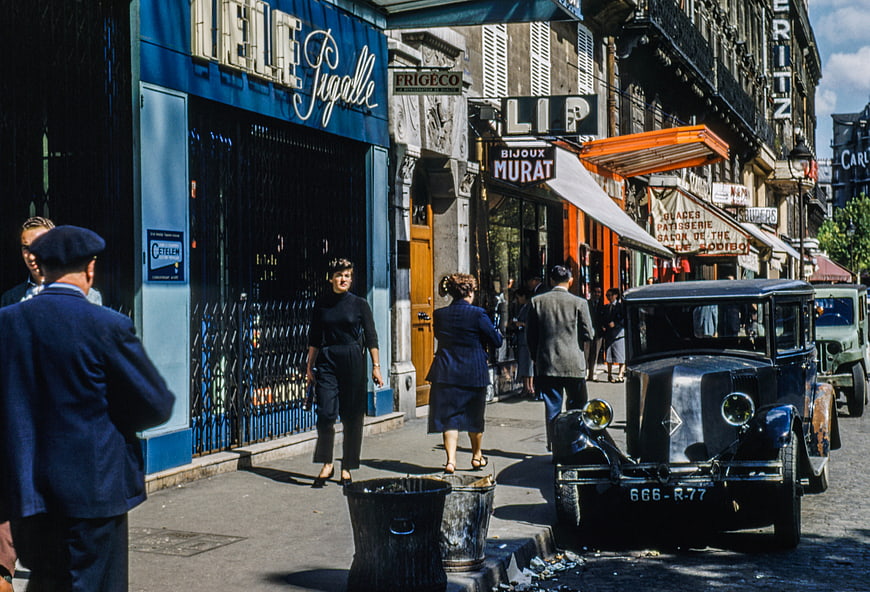 Vintage French Street Scene with Classic Car and Pedestrians